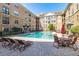 Inviting community pool surrounded by comfortable seating and umbrellas, perfect for relaxation at 4221 W Spruce St # 1229, Tampa, FL 33607