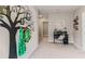 Spacious hallway with decorative wall art, desk, and neutral carpet at 4439 Sand Dollar Way, Zephyrhills, FL 33541