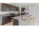 Modern kitchen with granite countertops, stainless steel appliances, and bar seating at 4439 Sand Dollar Way, Zephyrhills, FL 33541