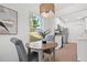 Cozy dining area adjacent to a modern white kitchen with bar seating at 4561 21St S Ave, St Petersburg, FL 33711