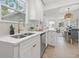 Kitchen with stainless steel appliances, modern white cabinetry, and view to dining room at 4561 21St S Ave, St Petersburg, FL 33711