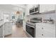 Open concept kitchen featuring modern appliances and seamless flow into the dining area at 4561 21St S Ave, St Petersburg, FL 33711