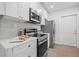 Bright kitchen with stainless steel appliances, white cabinets, and a stylish countertop at 4561 21St S Ave, St Petersburg, FL 33711