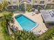 Aerial view of a sparkling community pool with surrounding patio and lounge chairs at 4681 1St Ne St # 306, St Petersburg, FL 33703