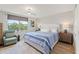Bedroom with a large window, ceiling fan and hardwood style flooring at 4681 1St Ne St # 306, St Petersburg, FL 33703