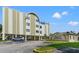 Beautiful exterior of Racquet Club Northeast Condominiums with covered parking and manicured landscaping at 4681 1St Ne St # 306, St Petersburg, FL 33703
