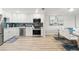 Modern kitchen featuring stainless steel appliances, white cabinets, and stylish backsplash at 4681 1St Ne St # 306, St Petersburg, FL 33703