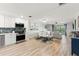 Open-concept living area with modern kitchen, dining space, and living room with balcony access at 4681 1St Ne St # 306, St Petersburg, FL 33703