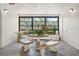 Bright airy lobby with beautiful stone table and seating area, surrounded by plants and greenery at 4681 1St Ne St # 306, St Petersburg, FL 33703