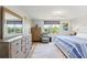 Bright main bedroom featuring wood dresser, calming accents and natural light through large windows at 4681 1St Ne St # 306, St Petersburg, FL 33703