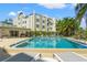 A beautiful refreshing swimming pool surrounded by palm trees and plenty of comfortable seating at 4681 1St Ne St # 306, St Petersburg, FL 33703