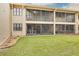 Backyard featuring a well-maintained lawn and screened in patios or balconies at 50 St Andrews Pl # 50, Oldsmar, FL 34677