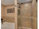 Bathroom featuring a tiled walk-in shower and separate bathtub at 50 St Andrews Pl # 50, Oldsmar, FL 34677