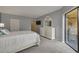 Bright bedroom with a white dresser and access to a private balcony at 50 St Andrews Pl # 50, Oldsmar, FL 34677