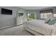 Cozy bedroom featuring a comfortable bed and a dresser with mirror at 50 St Andrews Pl # 50, Oldsmar, FL 34677