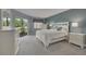 Inviting bedroom with white furniture, soft gray carpet and sliding glass doors to lanai at 50 St Andrews Pl # 50, Oldsmar, FL 34677