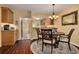 Cozy dining area featuring a round table, elegant chairs, and hardwood floors at 50 St Andrews Pl # 50, Oldsmar, FL 34677
