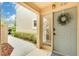 Charming condo front entrance with tasteful decor, inviting pathway, and ample natural light at 50 St Andrews Pl # 50, Oldsmar, FL 34677