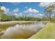 Scenic view of the golf course and water feature on a sunny day with blue skies at 50 St Andrews Pl # 50, Oldsmar, FL 34677