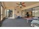 Spacious screened lanai with seating, fan, and access to both the living room and bedroom at 50 St Andrews Pl # 50, Oldsmar, FL 34677