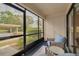 A cozy lanai featuring comfortable seating and views of the community parking area at 50 St Andrews Pl # 50, Oldsmar, FL 34677
