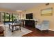 Bright living room with hardwood floors, comfortable seating, and sliding doors to the lanai at 50 St Andrews Pl # 50, Oldsmar, FL 34677