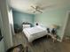 Bedroom with wood floors, fan, a double bed, and serene blue walls at 501 East Bay Dr. # 2003, Largo, FL 33770