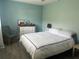 A comfortably designed bedroom with wood flooring, fan and blue walls at 501 East Bay Dr. # 2003, Largo, FL 33770