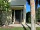 Charming front entrance featuring address numbers, dark door and shutters, and mature landscaping at 501 East Bay Dr. # 2003, Largo, FL 33770