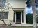 Charming front entrance featuring address numbers, dark door and shutters, and mature landscaping at 501 East Bay Dr. # 2003, Largo, FL 33770