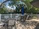 Relax and socialize in this inviting outdoor seating area with tables, chairs, and shade umbrellas at 501 East Bay Dr. # 2003, Largo, FL 33770
