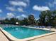 Community pool with plenty of lounge chairs for residents to enjoy under sunny skies at 501 East Bay Dr. # 2003, Largo, FL 33770