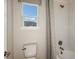 Clean bathroom features a toilet, a tub and shower, and a window providing natural light at 5128 Slate Hue Pl, Apollo Beach, FL 33572