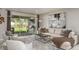 Bright living room featuring a comfortable sofa, stylish decor, and sliding glass doors to the patio at 5128 Slate Hue Pl, Apollo Beach, FL 33572