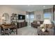 Cozy living area with comfortable seating, large windows, a TV, desk, and modern decor at 5128 Slate Hue Pl, Apollo Beach, FL 33572