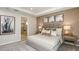 Comfortable bedroom with a king bed, neutral decor, ensuite bathroom with walk-in shower at 5128 Slate Hue Pl, Apollo Beach, FL 33572