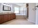 Bathroom view with double vanity, granite countertop, bathtub, and glass-enclosed shower at 513 Tweed Ave, Seffner, FL 33584