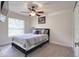 Bedroom with neutral walls and flooring with large window and ceiling fan at 513 Tweed Ave, Seffner, FL 33584