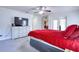 Bright bedroom with carpet floors, ceiling fan, and a comfortable bed at 513 Tweed Ave, Seffner, FL 33584