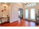 Bright foyer with hardwood floors, coat closet, and view of the living spaces at 513 Tweed Ave, Seffner, FL 33584