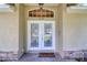 Elegant double front doors with transom window offer a warm welcome to the home at 513 Tweed Ave, Seffner, FL 33584