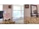 A decorated island featuring a granite countertop and tiled backsplash accents this area at 513 Tweed Ave, Seffner, FL 33584