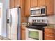 Close up shot of the stainless steel appliances, light colored countertops, and beautiful cabinets at 513 Tweed Ave, Seffner, FL 33584