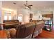 Open living room flows to kitchen with hardwood floors and neutral color scheme for relaxation at 513 Tweed Ave, Seffner, FL 33584