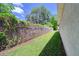 View of the home's side yard with well manicured landscaping at 513 Tweed Ave, Seffner, FL 33584