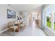 Bright dining room featuring tile floors, stylish decor, and a large window at 5224 Salt Marsh Rd, Wimauma, FL 33598