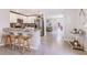Modern kitchen with white cabinets, stainless steel appliances, granite countertops, and an island with bar seating at 5226 Salt Marsh Rd, Wimauma, FL 33598