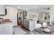 A well-lit kitchen with stainless steel appliances and gray cabinetry at 5231 Salt Marsh Rd, Wimauma, FL 33598