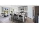 Modern kitchen with stainless steel appliances and a granite countertop island with seating at 5231 Salt Marsh Rd, Wimauma, FL 33598