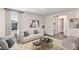 Inviting living room with a sofa, armchairs, and view to carpeted hallway at 5231 Salt Marsh Rd, Wimauma, FL 33598